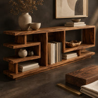 Corner detail of open shelf console table with stepped square cubbies on a slim plinth beside wood, brass and linen samples