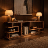 Open shelf console table with stepped square cubbies on a slim plinth in an evening entryway with walnut wall paneling