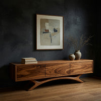 TV stand with three doors on an antler shaped base in a dark studio against a charcoal wall