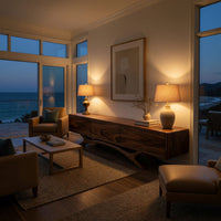 TV stand with three doors on an antler shaped base in an evening room lit by two lamps