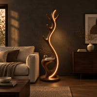 Tall floor lamp shaped like an antler with a hollow in the lower body in a dark living room at golden hour