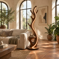 Tall floor lamp shaped like an antler with a hollow in the lower body in a bright living room with arched windows and plants