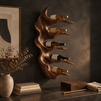 Corner detail of antler style wine holder with stacked prongs and flowing grain beside wood, brass and linen samples
