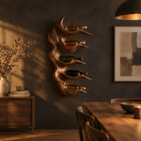 Antler style wine holder with stacked prongs and flowing grain in a dark dining room at golden hour