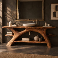 Corner detail of branch leg bathroom vanity with a slab top, open lower shelf and side ledges beside wood, brass and linen samples