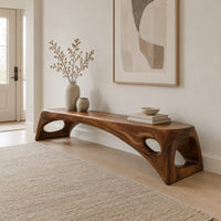 Arched bench with oval cutouts in the end legs in a Scandinavian entryway with white walls