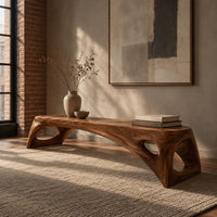 Arched bench with oval cutouts in the end legs in an industrial loft entryway with exposed brick
