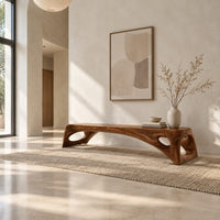 Arched bench with oval cutouts in the end legs in a bright open plan entryway