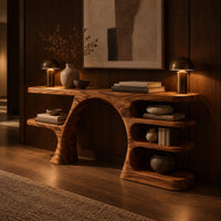 Arched console table with a branch shaped leg and stacked oval shelves in an evening entryway with walnut wall paneling