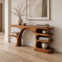 Arched console table with a branch shaped leg and stacked oval shelves in a Scandinavian entryway with white walls