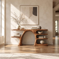 Arched console table with a branch shaped leg and stacked oval shelves in a bright open plan entryway