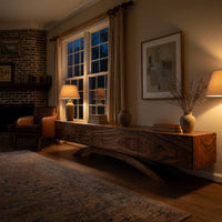 Four door TV cabinet on arched sculpted legs in an evening room lit by two lamps