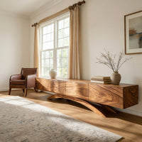 Four door TV cabinet on arched sculpted legs in a bright modern living room