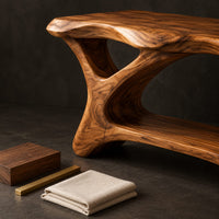 Corner detail of freestanding vanity with a long slab top on an asymmetric sculpted base beside wood, brass and linen samples