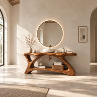 Freestanding vanity with a long slab top on an asymmetric sculpted base in a bright open plan bathroom