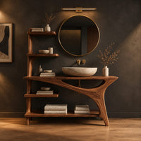 Asymmetric bathroom vanity with a tall side shelf stack and a swept leg in a dark studio against a charcoal plaster wall