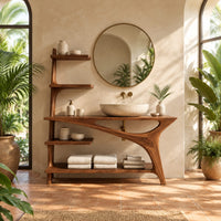 Asymmetric bathroom vanity with a tall side shelf stack and a swept leg in a bright bathroom with arched windows and plants