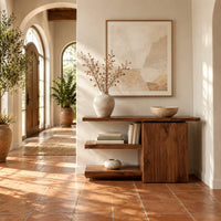 Asymmetric console table with two open shelves beside a closed wood block in a bright entryway with arched windows and plants