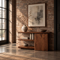 Asymmetric console table with two open shelves beside a closed wood block in an industrial loft entryway with exposed brick