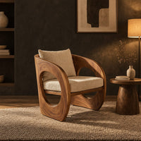 Barrel lounge chair with round cutouts in curved side panels in a dark living room at golden hour