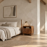 Barrel sided nightstand with an open top cubby and a swirled grain front in a bright open plan bedroom