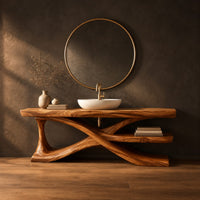 Bathroom vanity on crossed sculpted legs with a lower shelf in a dark studio against a charcoal plaster wall