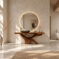 Freestanding bathroom vanity with a thick slab top on a carved forked base in a bright open plan bathroom