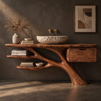 Corner detail of bathroom vanity with a branching trunk base, two leaf shaped shelves and one drawer beside wood, brass and linen samples