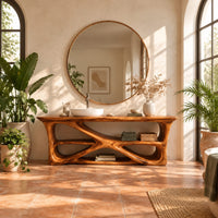 Freestanding vanity on a branching loop frame with open shelf spaces in a bright bathroom with arched windows and plants