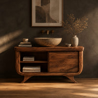 Bathroom vanity with an open cubby and one door on flared feet in a dark studio against a charcoal plaster wall