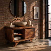 Bathroom vanity with an open cubby and one door on flared feet in an industrial loft bathroom with exposed brick