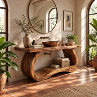 Bathroom vanity with a thick slab top on a sculpted loop base in a bright bathroom with arched windows and plants