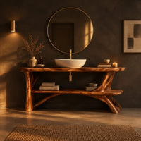 Bathroom vanity with sculpted tree limb legs and a wide lower shelf in a dark bathroom at golden hour