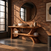 Bathroom vanity with sculpted tree limb legs and a wide lower shelf in an industrial loft bathroom with exposed brick