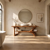 Bathroom vanity with sculpted tree limb legs and a wide lower shelf in a bright open plan bathroom