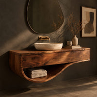 Corner detail of floating bathroom vanity with a two panel front and sweeping open shelf beside wood, brass and linen samples