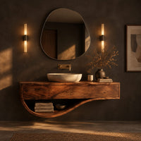 Floating bathroom vanity with a two panel front and sweeping open shelf in a dark bathroom at golden hour