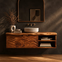 Bathroom vanity with wave carved doors and an open shelf bay in a dark studio against a charcoal plaster wall