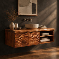Bathroom vanity with wave carved doors and an open shelf bay, three-quarter view showing the grain