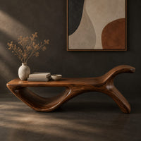 Corner detail of long flat bench with an open loop base and one raised end beside wood, brass and linen samples