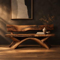 Bench with a natural edge slab back and angled arched legs in a dark studio against a charcoal plaster wall
