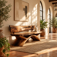 Bench with a natural edge slab back and angled arched legs in a bright entryway with arched windows and plants