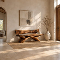 Bench with a natural edge slab back and angled arched legs in a bright open plan entryway