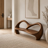 Bench with an open looping backrest and sculpted legs in a Scandinavian entryway with white walls