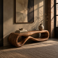 Low wood bench shaped as a figure eight loop with a smooth top in an industrial loft entryway with exposed brick