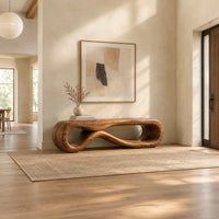 Low wood bench shaped as a figure eight loop with a smooth top in a bright open plan entryway