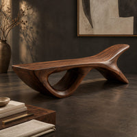 Corner detail of bench with a fish tail upsweep and a large open arch beside wood, brass and linen samples