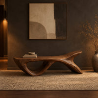 Bench with a fish tail upsweep and a large open arch in a dark entryway at golden hour