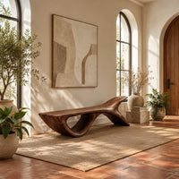 Bench with a fish tail upsweep and a large open arch in a bright entryway with arched windows and plants