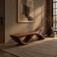 Bench with a fish tail upsweep and a large open arch in an industrial loft entryway with exposed brick